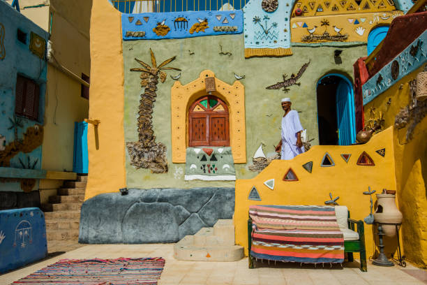 A Nubian man walks outside a traditional Nubian house, Aswan Egypt, August 2015