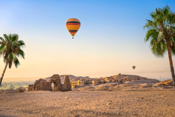 Hot air balloon over ruins of Hatshepsut temple in Luxor, Egypt